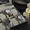 Cutie de ceas cu 12 compartimente, capac de sticlă, imitație de piele neagră, căptușeală bej-verzuie